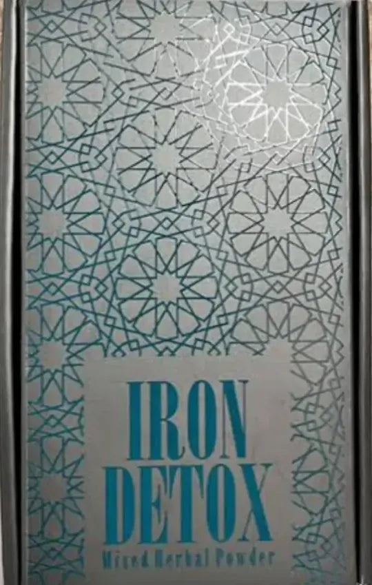 Iron Tea sachet beside a steaming cup of rich herbal infusion