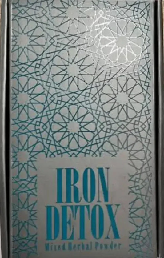 Iron Tea sachet beside a steaming cup of rich herbal infusion